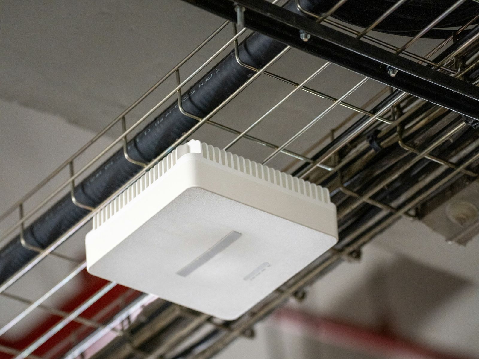 Wi-Fi access point mounted under a ceiling cable tray